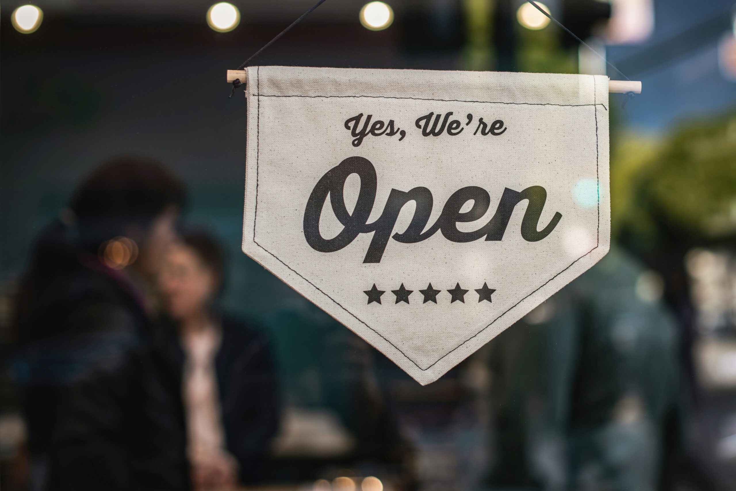 Sign on a store window indicating a small business.